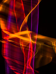 colorful light trails in dark background. Abstract light routes that rotate in vibrant colors. Forestry of the blurry movement of light painting. Blurred lights at night. Intentional camera movement, 