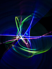 colorful light trails in dark background. Abstract light routes that rotate in vibrant colors. Forestry of the blurry movement of light painting. Blurred lights at night. Intentional camera movement, 