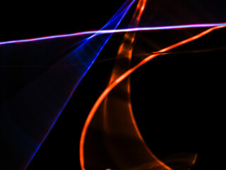 colorful light trails in dark background. Abstract light routes that rotate in vibrant colors. Forestry of the blurry movement of light painting. Blurred lights at night. Intentional camera movement, 