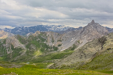 Green mountains with granite peaks tops with glaciers in La Vanoise national park, France 