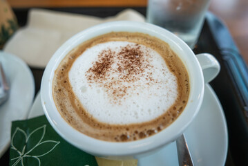 Savoring a rich coffee beverage cozy  warm ambiance close-up view inviting comfort