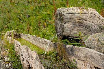 drinking fountain and wooden trough in the French alps