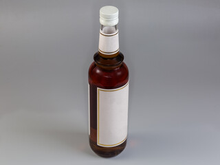 Bottle of hazelnut syrup on a gray background