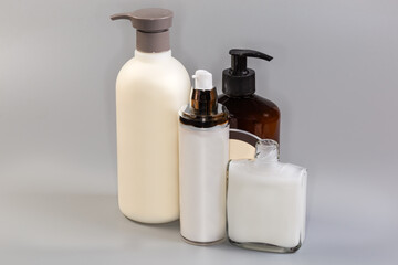 Different bottles of cosmetic creams and shower gels and shampoo