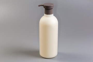 White round plastic bottle of shower gel with push dispenser