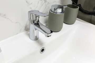 Handle mixer tap installed on a washbasin in the bathroom