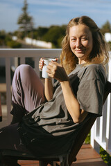 Woman Enjoying Morning Coffee on Home Terrace