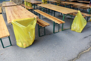 An Outdoor Dining Area that features Yellow Trash Bins for efficient waste management