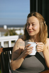 Woman Enjoying Morning Coffee on Home Terrace