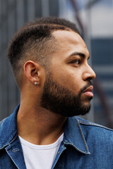 Obraz premium Profile of african american man in denim jacket standing on street
