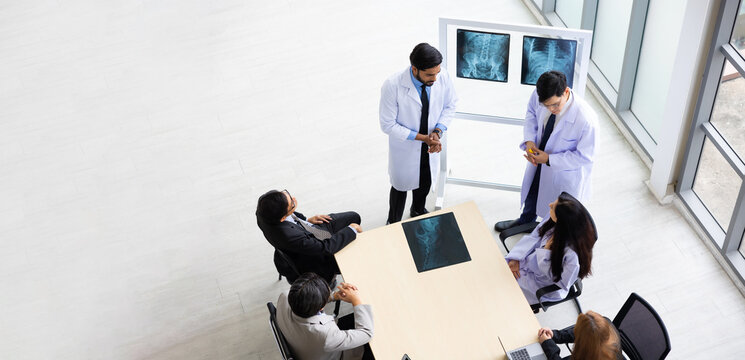 High angle top view, Above Hospital Medical Research : Group of Doctor, nurse and healthcare professional team meeting sitting in the boardroom,  Planning and brainstorming health