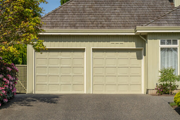 Garage door in luxury house with trees and nice landscape in Spring in Vancouver, Canada, North...