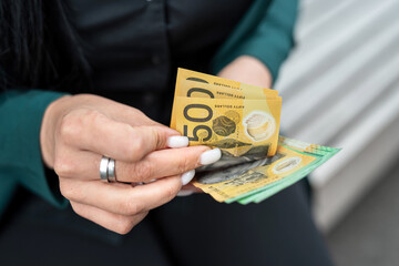 woman is holding an new 50 100 Australian currency. Concept of economy and finance