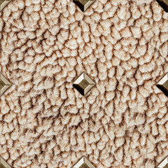 Seamless 4k photo texture of light brown astrakhan wool material with studs.