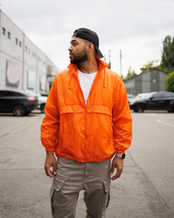 Stylish african american man in street wear looking away outdoors 
