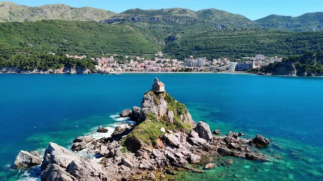 Aerial drone view of the Sveta Nedelja church in Montenegro. A Christian church on a tiny rocky island in the sea near the town of Petrovac.