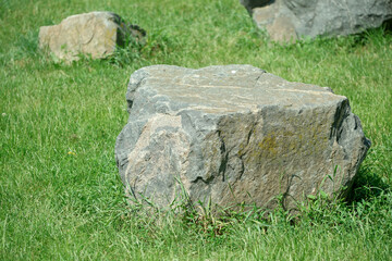 Natural stones scattered across a lush green grassy landscape