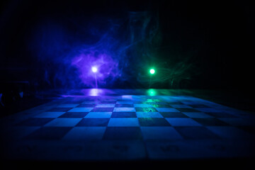 Chess board game concept of business ideas and competition. Chess figures on a dark background with smoke and fog.