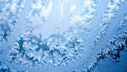 Intricate ice crystal formations creating elegant snowflake designs on frosted glass with soft glow