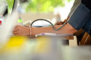 Annual checkup concept. Doctor is measuring patient's blood pressure. The patient has a blood pressure cuff on his arm.