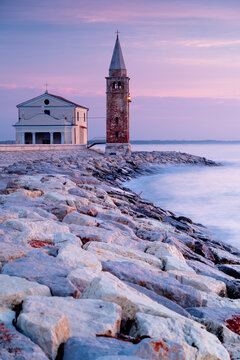 Lighthouse in Caorle, Italy. Italian coastal city in the metropolis of Venice. Church of the Madonna dell'Angelo.	
