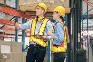 Caucasian man, woman warehouse supervisor discuss and use tablet check package with forklift driver worker load box on shelf, product distribution inventory management,Logistics shipping business plan