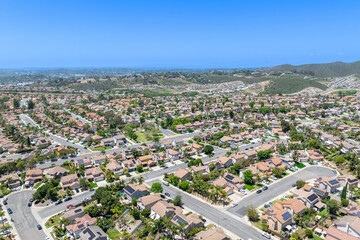 Aerial view of San Marcos neighborhood with houses and street during sunny day, South California, USA.