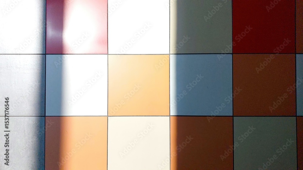 Poster Colorful Tiled Floor With Shadows Creating Patterns in a Well-Lit Indoor Space During the Day