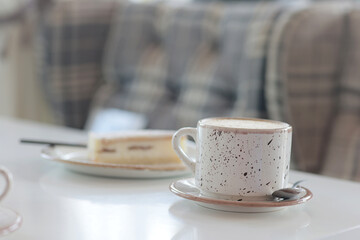 a cup of coffee in the interior of a cozy cafe for breakfast