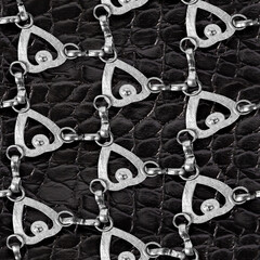 Seamless 4k photo texture material of black reptile polished leather surface with metal mesh.