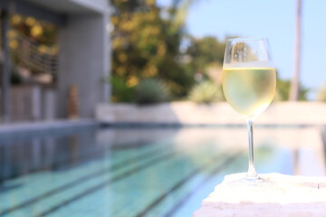 Wine glass close-up in real life, beautiful blurred background of the drink in the glass