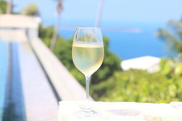 a glass of cold white wine and serving in the restaurant