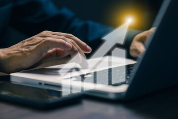 Businessman's hands typing on laptop keyboard with upward arrow growth graph overlay, symbolizing digital marketing success, business analytics, and online financial growth.