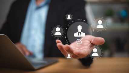 Recruit employee, Businessman selects a user icon from a digital interface, representing HR technology, customer segmentation, and AI driven decision-making in recruitment and business strategy.