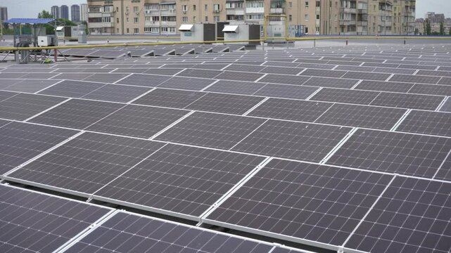 A field of solar panels on the roof of a building.