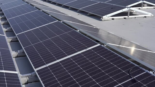 Workers installing solar panels on the roof of a building