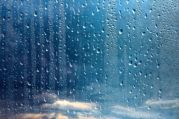 raindrops on wet glass abstract background on the backdrop of the sky