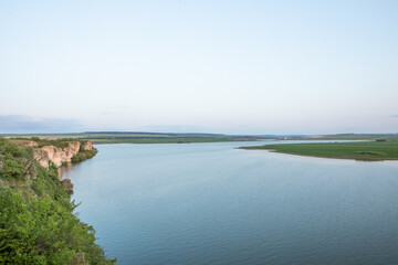 Beautiful natural landscape in the north of the Republic of Moldova with the Prut River and steep cliffs.