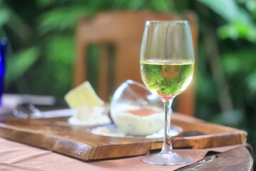 a glass of white wine served in a restaurant, abstract background of a summer restaurant