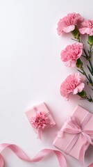 Obraz premium Elegant pink carnations and gift boxes with ribbons arranged on a white background