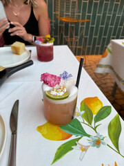 Cocktail with edible flower served at restaurant