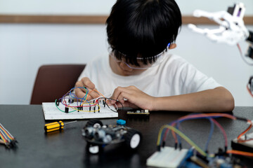 young boy having fun connecting electronic circuit board