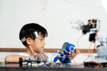 young boy having fun connecting electronic circuit board