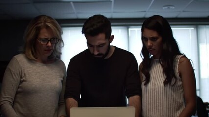 In a suspenseful atmosphere, three individuals of diverse backgrounds examine a crucial document together