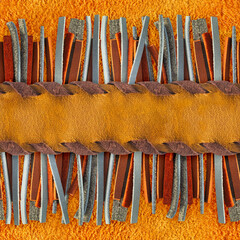 Seamless 4k photo texture material of leather fringe and braided strap on suede surface.