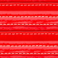 Seamless 4k photo texture material of red colored polished leather straps surface with stitches.
