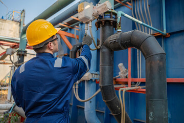 Engineers and technicians work at a water treatment and wastewater facility, monitoring systems,...