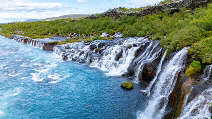 Discover the enchanting beauty of Barnafoss and Hraunfossar waterfalls in Iceland. Crystal-clear...