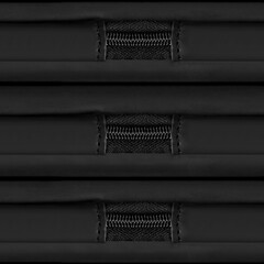 Seamless 4k photo texture material of synthetic black leather with plastic zippers.