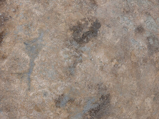 Rough texture of concrete wall with weathered surface in daylight